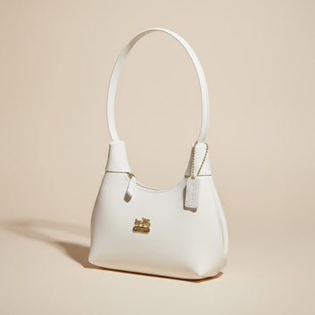 White Coach Handbag with Gold Logo